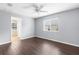 Spacious bedroom with hardwood floors, ceiling fan, and natural light from a window and door at 13384 Brighton St, Spring Hill, FL 34609