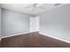 Neutral bedroom featuring a ceiling fan, hardwood floors, a window with blinds, and access to a closet at 13384 Brighton St, Spring Hill, FL 34609
