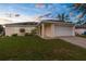 Charming single-story home with an attached two-car garage and manicured lawn at 13384 Brighton St, Spring Hill, FL 34609