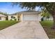Inviting single-story home with an attached two-car garage and a well-kept front yard at 13384 Brighton St, Spring Hill, FL 34609