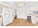 Bright kitchen features stainless steel appliances, light wood floors, bar seating, and a modern ceiling fan at 13384 Brighton St, Spring Hill, FL 34609