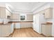 Functional kitchen with matching appliances, light cabinetry, and countertops with a view from the window at 13384 Brighton St, Spring Hill, FL 34609
