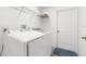 Bright laundry room featuring modern Samsung washer and dryer with overhead shelving for storage at 13384 Brighton St, Spring Hill, FL 34609