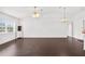 Bright and airy living room with ceiling fan, hardwood floors, and large windows at 13384 Brighton St, Spring Hill, FL 34609