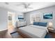 Comfortable main bedroom with wooden floors, a ceiling fan and plenty of natural light with art at 13384 Brighton St, Spring Hill, FL 34609