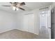 Neutral bedroom with ceiling fan, carpeted floor, and closet for storage at 14006 Amero Ln, Spring Hill, FL 34609