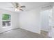 Bright bedroom featuring carpeted floor, a window to the outside, and white walls at 14006 Amero Ln, Spring Hill, FL 34609