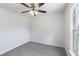 Bedroom featuring neutral carpet, a ceiling fan, and a bright window at 14006 Amero Ln, Spring Hill, FL 34609