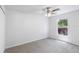 A neutral-toned bedroom features a ceiling fan, closet, and a window at 14006 Amero Ln, Spring Hill, FL 34609