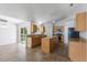 Open kitchen with center island, breakfast bar, stainless appliances, and a view to the backyard at 14006 Amero Ln, Spring Hill, FL 34609