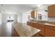 Bright kitchen featuring granite counters, light wood cabinets, island, and open view to the living area at 14006 Amero Ln, Spring Hill, FL 34609