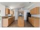 Spacious kitchen with light wood cabinets, granite countertops, stainless appliances, and tile flooring at 14006 Amero Ln, Spring Hill, FL 34609