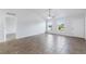 Open living area with high ceilings, tile floors, and large windows letting in natural light at 14006 Amero Ln, Spring Hill, FL 34609