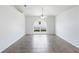 Open-concept living room with tile flooring, ceiling fan, and large arched window letting in natural light at 14006 Amero Ln, Spring Hill, FL 34609
