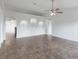 Spacious living room showcasing tile flooring and three decorative arched in-wall shelves at 14006 Amero Ln, Spring Hill, FL 34609