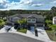Aerial view of townhomes featuring attached garages and well-manicured lawns at 1674 Roseville St, Lutz, FL 33549