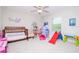 Playful ' bedroom featuring a bed, play area, and ceiling fan at 1674 Roseville St, Lutz, FL 33549