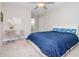 Cozy bedroom featuring neutral colors, plush carpet and a ceiling fan at 1674 Roseville St, Lutz, FL 33549