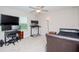 Functional bedroom featuring a ceiling fan, and dedicated workstation with multiple screens at 1674 Roseville St, Lutz, FL 33549
