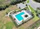 Aerial view of the community pool surrounded by seating and manicured green space at 1674 Roseville St, Lutz, FL 33549