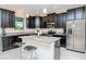 Charming kitchen features stainless steel appliances, granite counters, and breakfast bar at 1674 Roseville St, Lutz, FL 33549