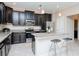 Modern kitchen boasts stainless appliances, granite counters, and breakfast bar at 1674 Roseville St, Lutz, FL 33549