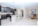 Modern kitchen boasts stainless appliances, a breakfast bar, and an adjacent dining area at 1674 Roseville St, Lutz, FL 33549