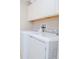 Bright laundry room featuring a washer and dryer, and convenient overhead cabinets at 1674 Roseville St, Lutz, FL 33549