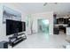Bright living room leading into the kitchen, and patio at 1674 Roseville St, Lutz, FL 33549