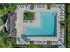 Aerial view of the pool and surrounding patio with lounge chairs, seating and lush landscaping at 1674 Roseville St, Lutz, FL 33549