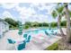 Inviting community pool with ample seating, lounge chairs and tables with shade umbrellas at 1674 Roseville St, Lutz, FL 33549