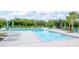 Large community pool with lounge chairs and shade umbrellas offering a relaxing environment at 1674 Roseville St, Lutz, FL 33549