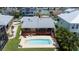 Aerial shot of a home with a private pool, a spacious deck, and lush greenery at 17025 Dolphin Dr, North Redington Beach, FL 33708