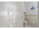 Bathroom with tile walls and floors, and an anchor decoration at 17025 Dolphin Dr, North Redington Beach, FL 33708