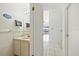 A powder room featuring a vanity and doorway to the main hall at 17025 Dolphin Dr, North Redington Beach, FL 33708