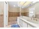 Bathroom featuring double sinks, a soaking tub, and a large mirror at 17025 Dolphin Dr, North Redington Beach, FL 33708
