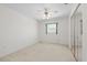 Bedroom with a ceiling fan, window, and sliding glass door closet at 17025 Dolphin Dr, North Redington Beach, FL 33708