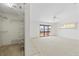Bright bedroom with sliding glass doors, carpeted floor, ceiling fan, and closet at 17025 Dolphin Dr, North Redington Beach, FL 33708