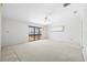 Spacious bedroom with a ceiling fan, sliding glass door, and natural light at 17025 Dolphin Dr, North Redington Beach, FL 33708