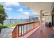 Relax on the deck overlooking the pool and waterfront, complete with a ceiling fan and comfortable seating at 17025 Dolphin Dr, North Redington Beach, FL 33708