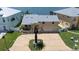 Aerial view showcasing the home's exterior, driveway, well-manicured lawn, and surrounding neighborhood at 17025 Dolphin Dr, North Redington Beach, FL 33708