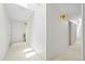 Hallway features bright white walls, carpet flooring, and sconce lighting at 17025 Dolphin Dr, North Redington Beach, FL 33708