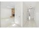 Hallway leading to a room with stone fireplace and tiled floor at 17025 Dolphin Dr, North Redington Beach, FL 33708