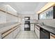 Bright kitchen with white cabinets, modern appliances, and tile flooring at 17025 Dolphin Dr, North Redington Beach, FL 33708