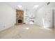Bright living room features a stone fireplace, carpeted floor, and skylights at 17025 Dolphin Dr, North Redington Beach, FL 33708