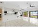 Spacious living room with tiled floors, ceiling fans, and water view at 17025 Dolphin Dr, North Redington Beach, FL 33708