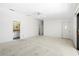A large living room with ample natural light, a ceiling fan, and exterior access at 17025 Dolphin Dr, North Redington Beach, FL 33708