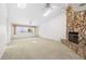 Bright living room featuring a stone fireplace, skylights and neutral carpet at 17025 Dolphin Dr, North Redington Beach, FL 33708