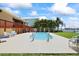 Waterfront backyard with a private pool, lush landscaping, deck, and chairs at 17025 Dolphin Dr, North Redington Beach, FL 33708