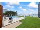 Waterfront backyard with a private pool, lush landscaping, deck and lawn at 17025 Dolphin Dr, North Redington Beach, FL 33708
